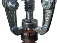 An external bearing puller removes a bearing from a shaft.