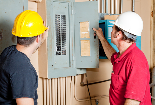 Electricians opening electrical panel door