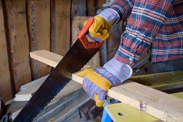 A hand saw cutting wood.