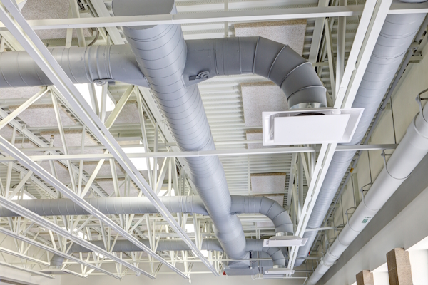 In industrial spaces, ductwork is used to transport conditioned air throughout the space.