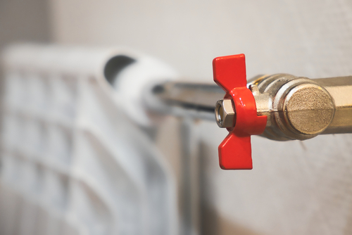 A ball valve on a water pipeline to a radiator.