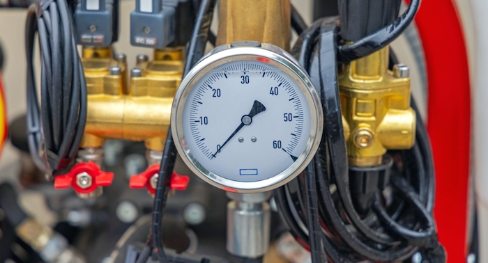 A liquid filled hydraulic pressure gauge on an agricultural machine.