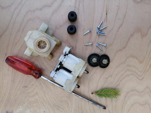 A solenoid valve from a washing machine disassembled for cleaning and repair.