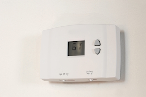 An HVAC thermostat mounted on the wall