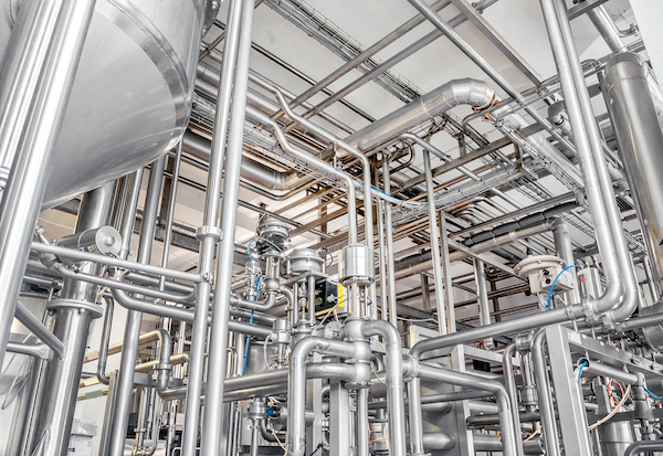 Stainless steel piping used in beverage and food-processing facilities.