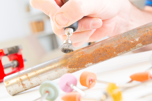 Wire brushes excel at cleaning rust from a pipe